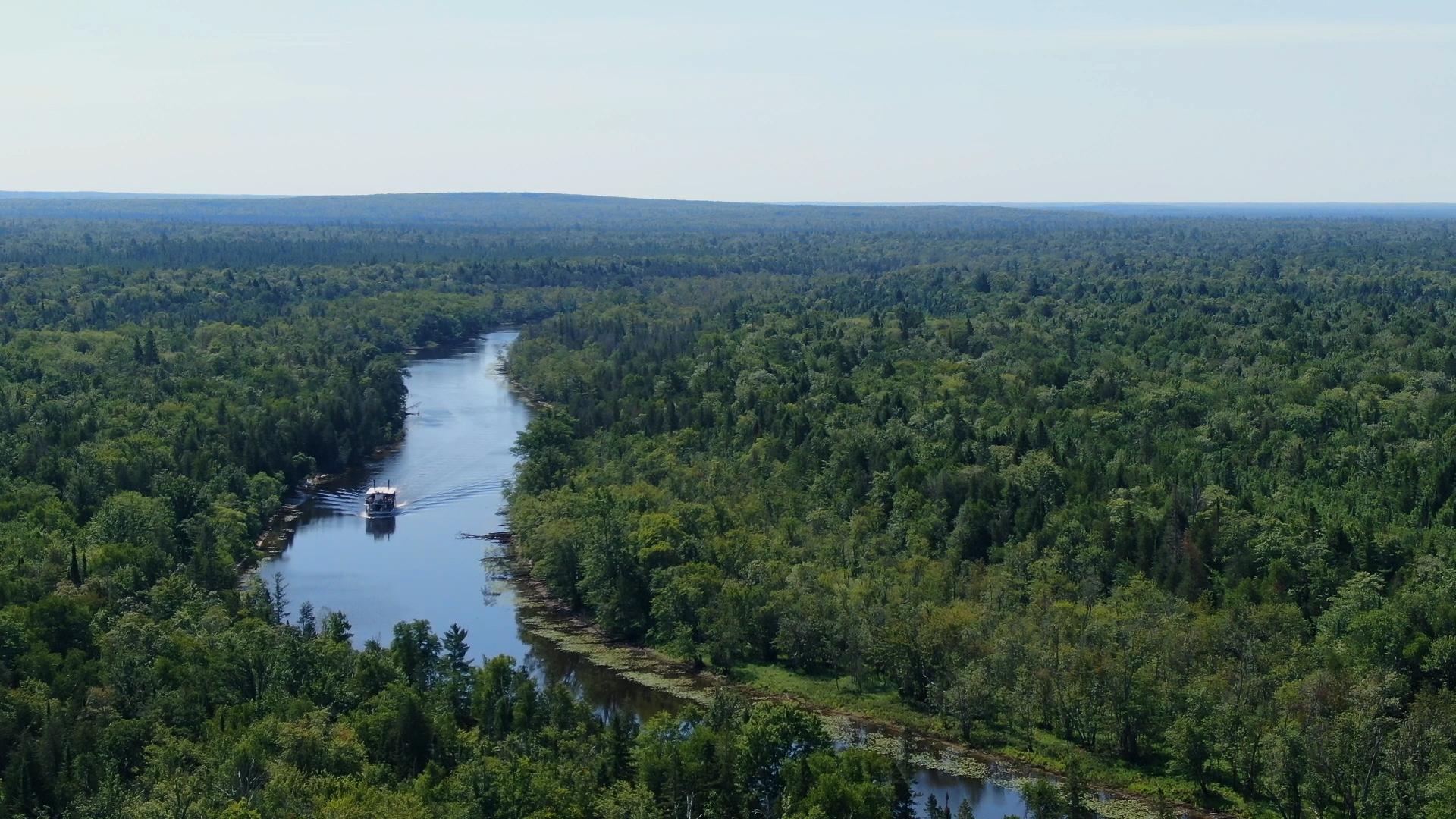 A birdseye view of the Tahquamenon Falls Riverboat moving along the river.
