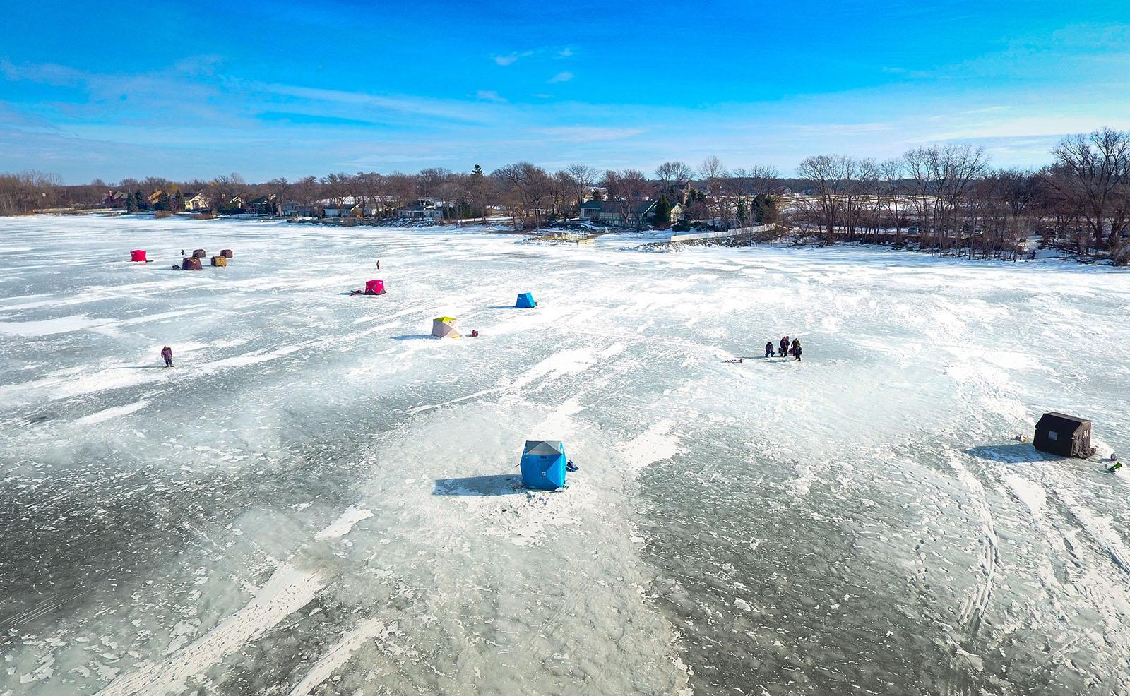 Ice shanties spread atop the iced over lake
