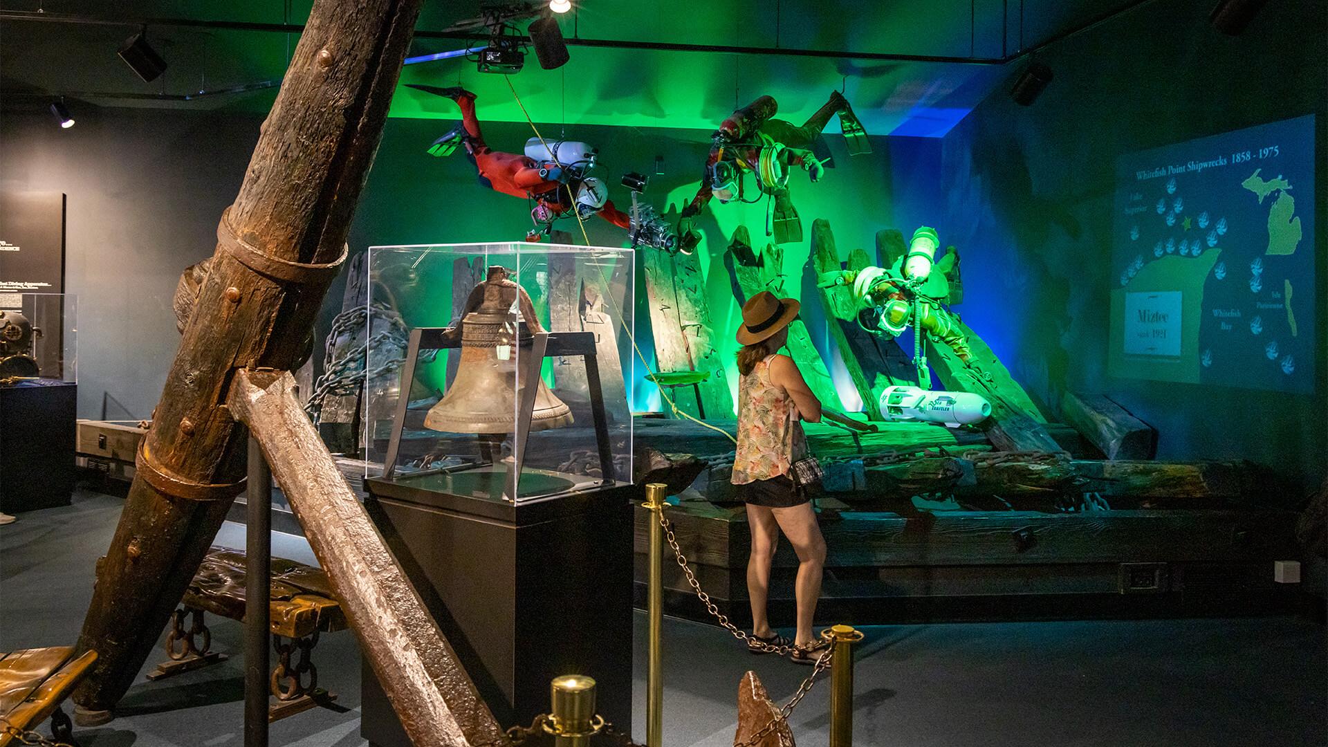 A woman looking at a scuba diving display at the Great Lakes Shipwreck Museum