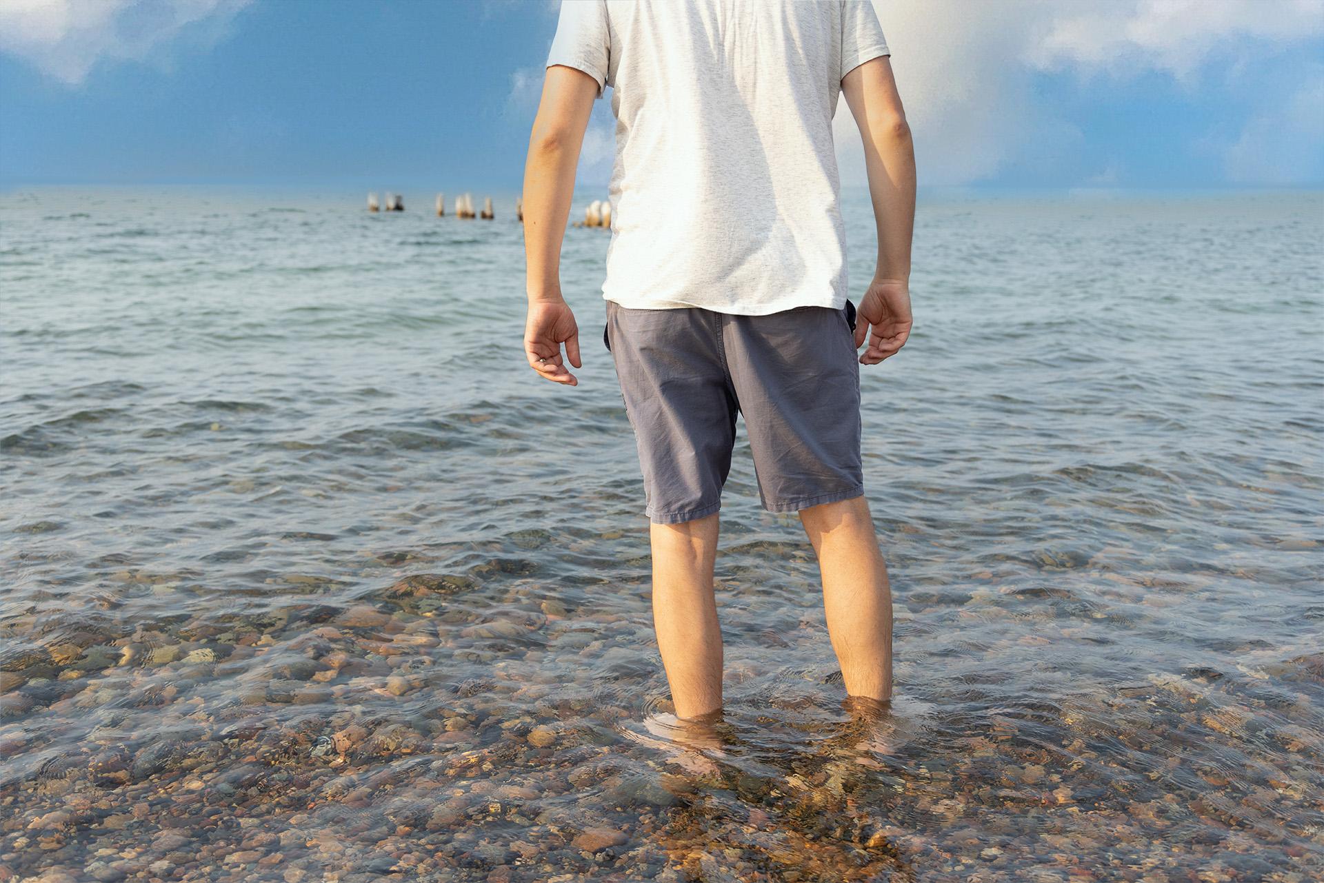 Person wading into Lake Superior at Whitefish Point