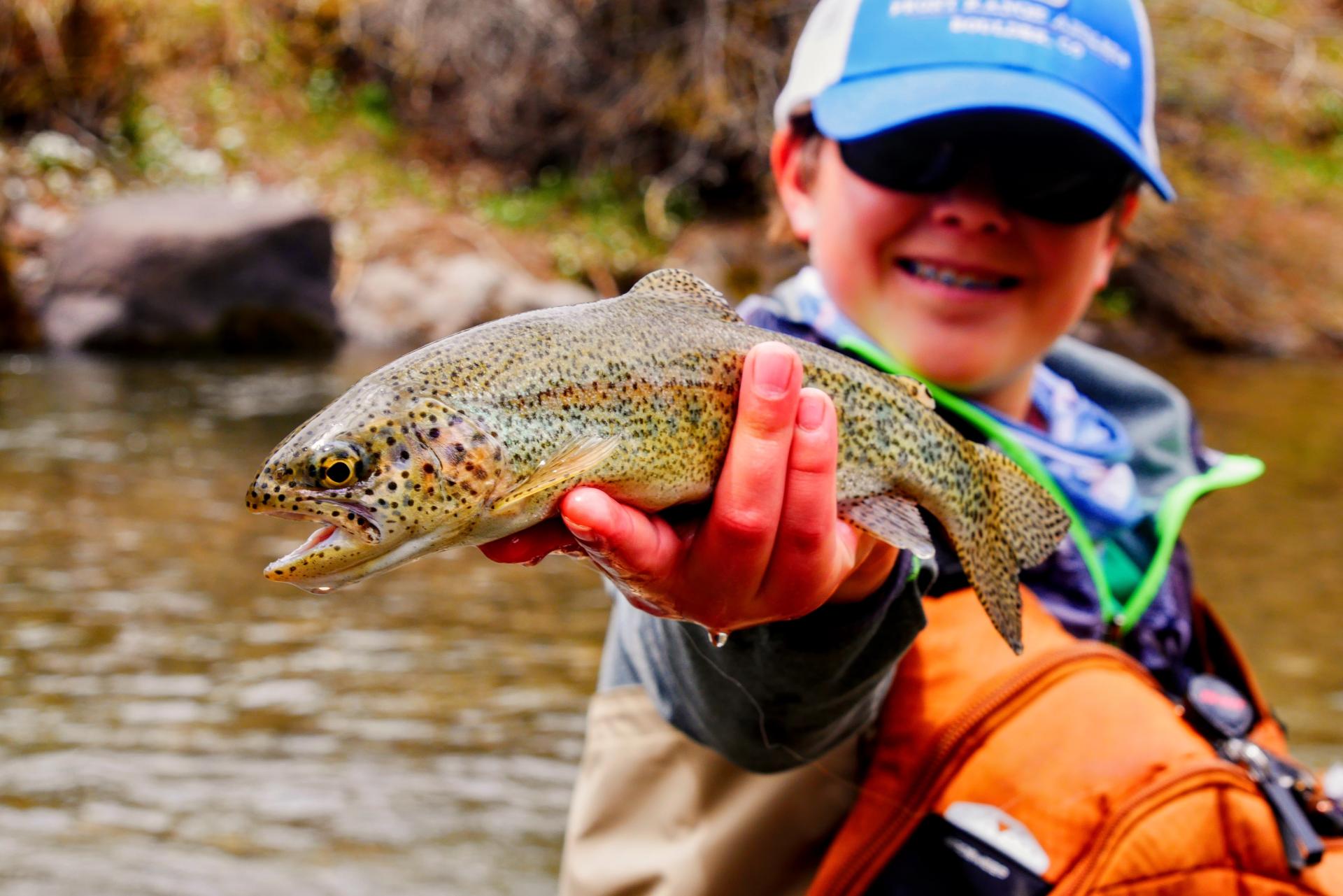 Boy holding a freshly caught fish