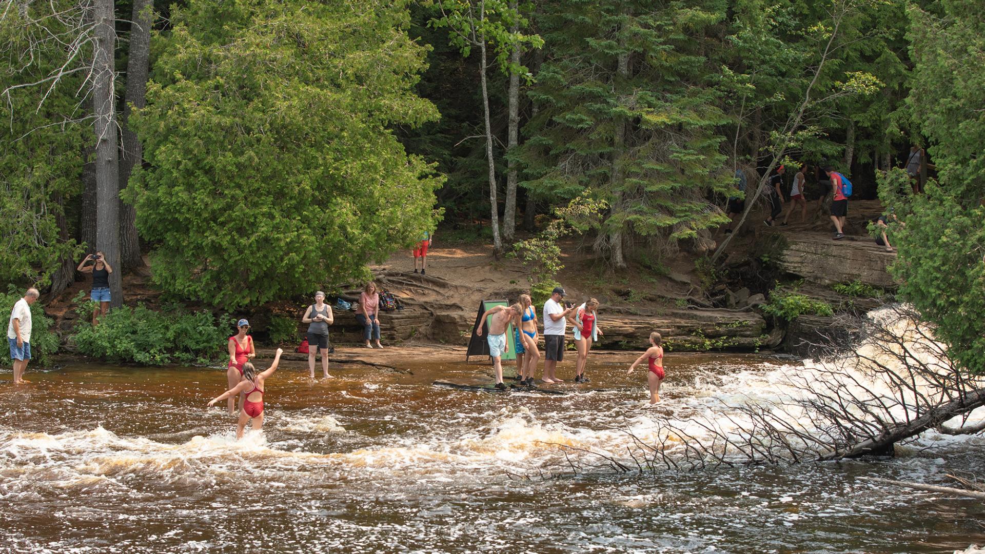 People playing in Lower Tahquamenon Falls