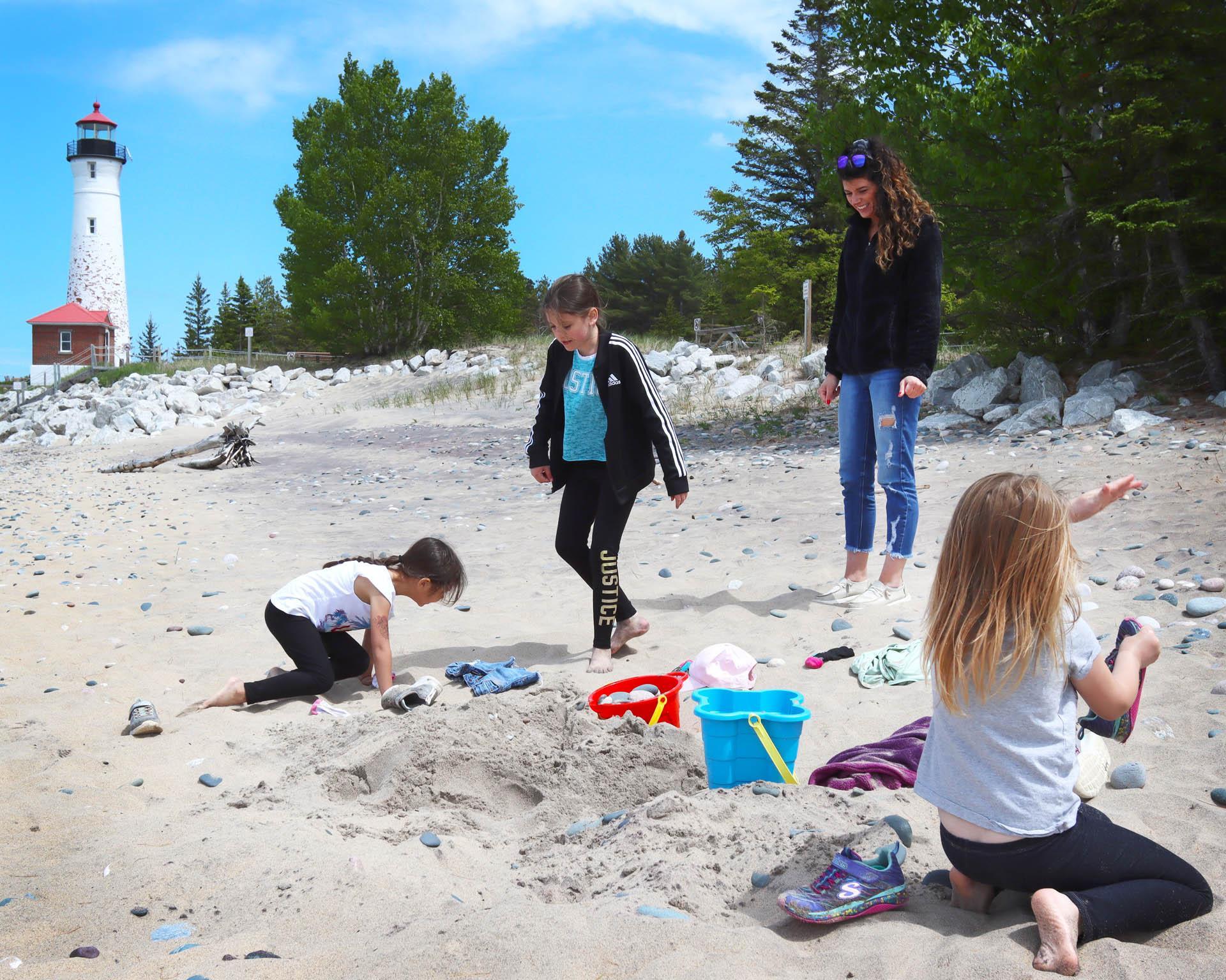 People on the beach at Crisp Point Lighthouse