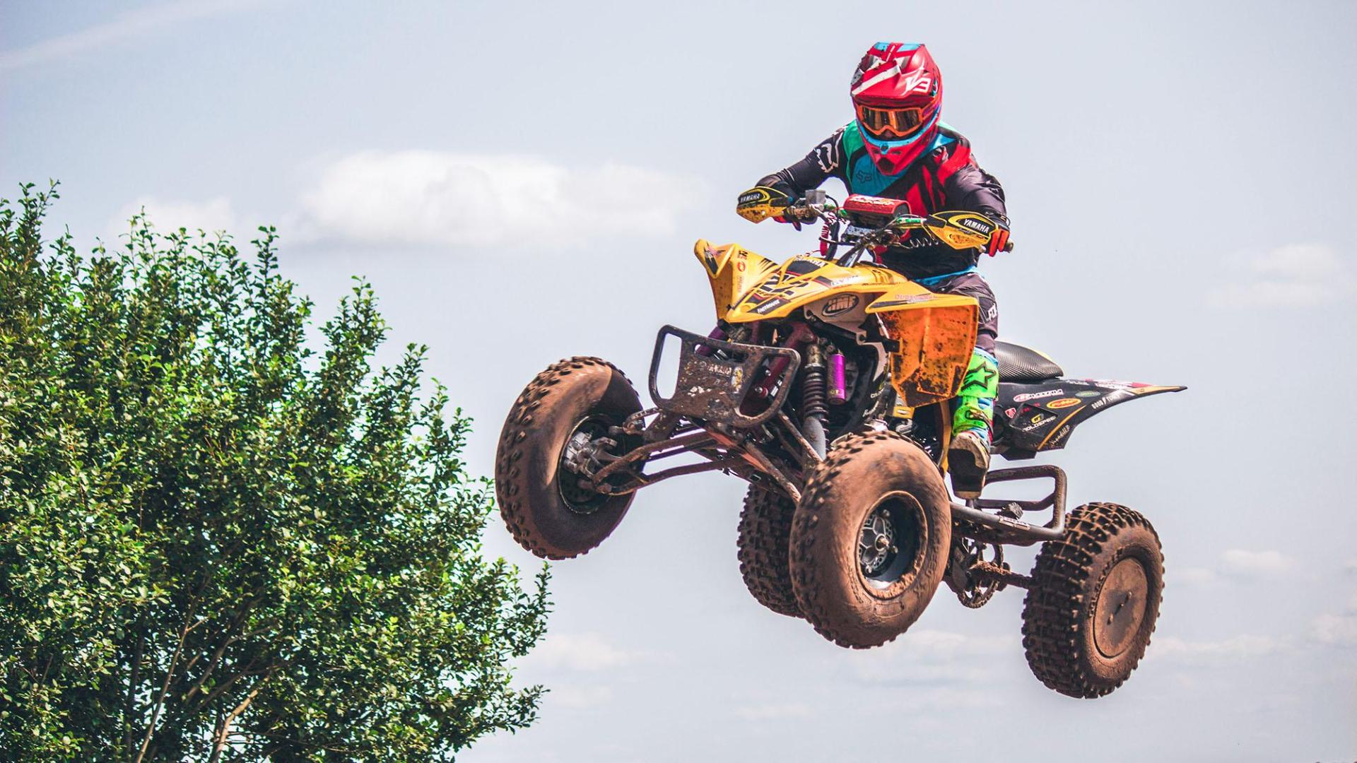 A person jumping an atv.