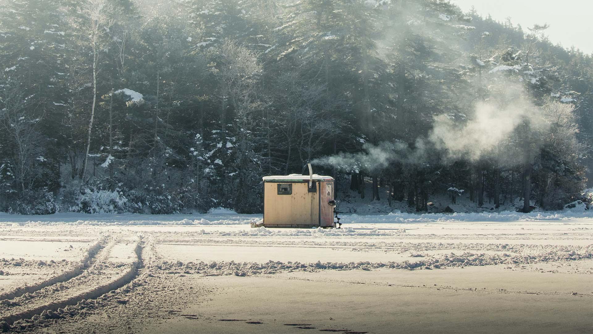 An ice shanty on a lake.