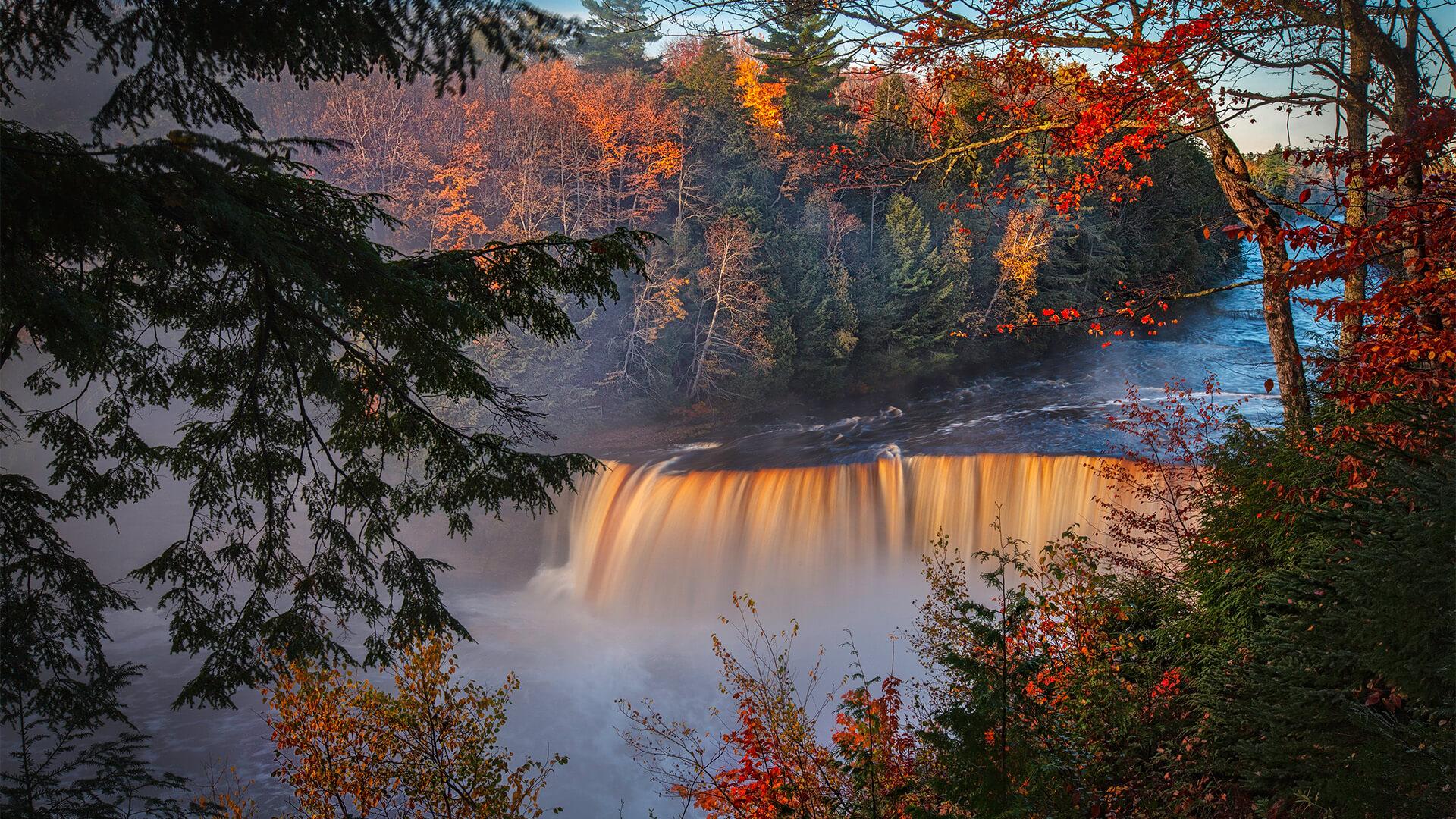 Upper Tahquamenon Falls surrounded by autumnal trees