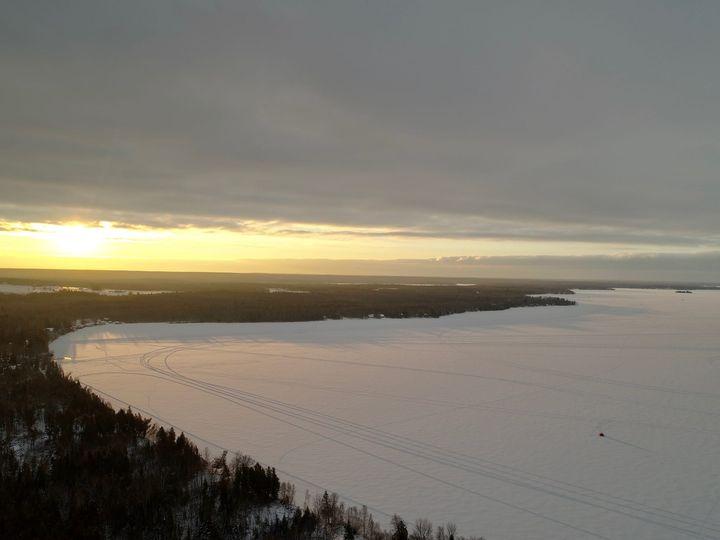 drone shot of Manistique Lake in winter