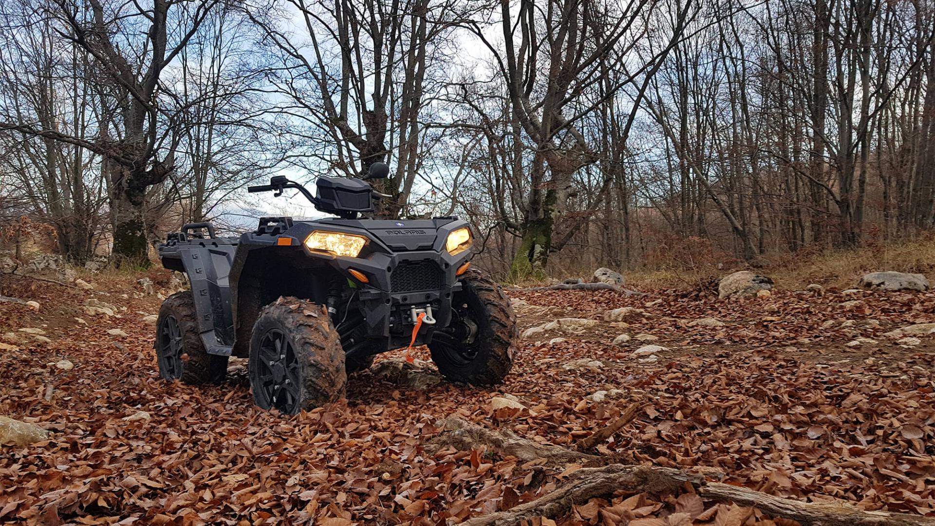 four-wheeler in a clearing in the woods during the fall
